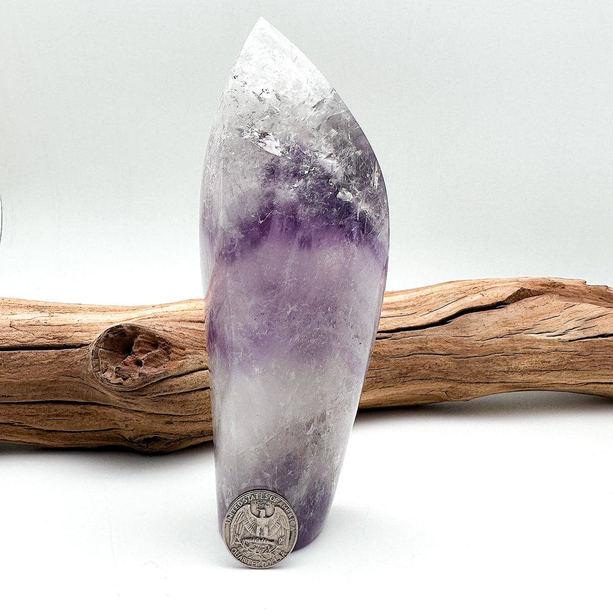 Full view comparison shot of a large Amethyst crystal and a US quarter coin