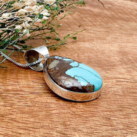 Shot of a boulder turquoise pendant as viewed from the side