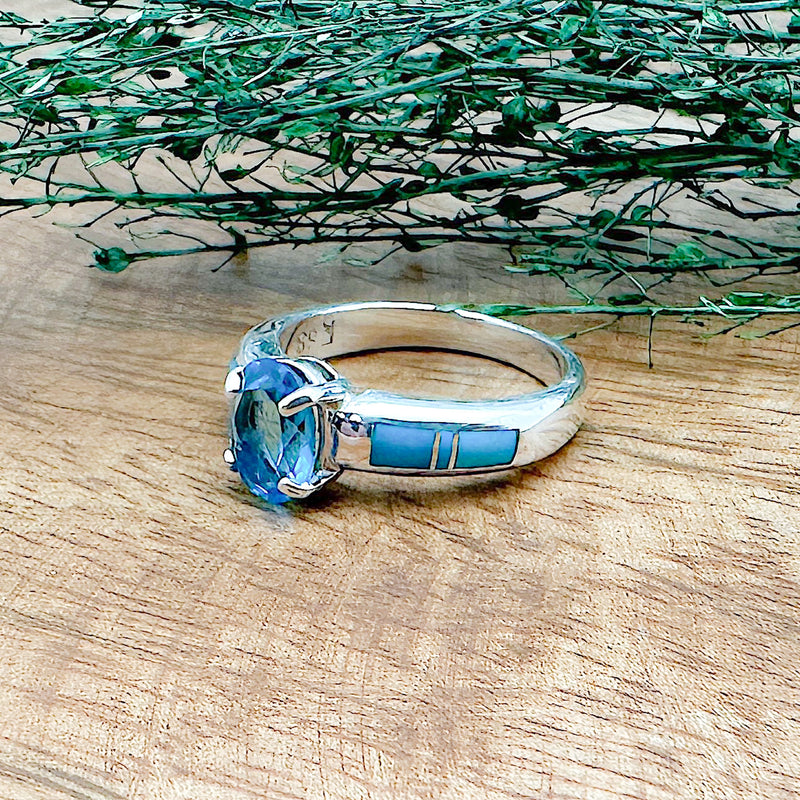 A handmade sterling silver ring that has 6 hand cut stones with Sleeping Beauty Turquoise and a London Blue Topaz on top that is a part of the David Rosales collection.