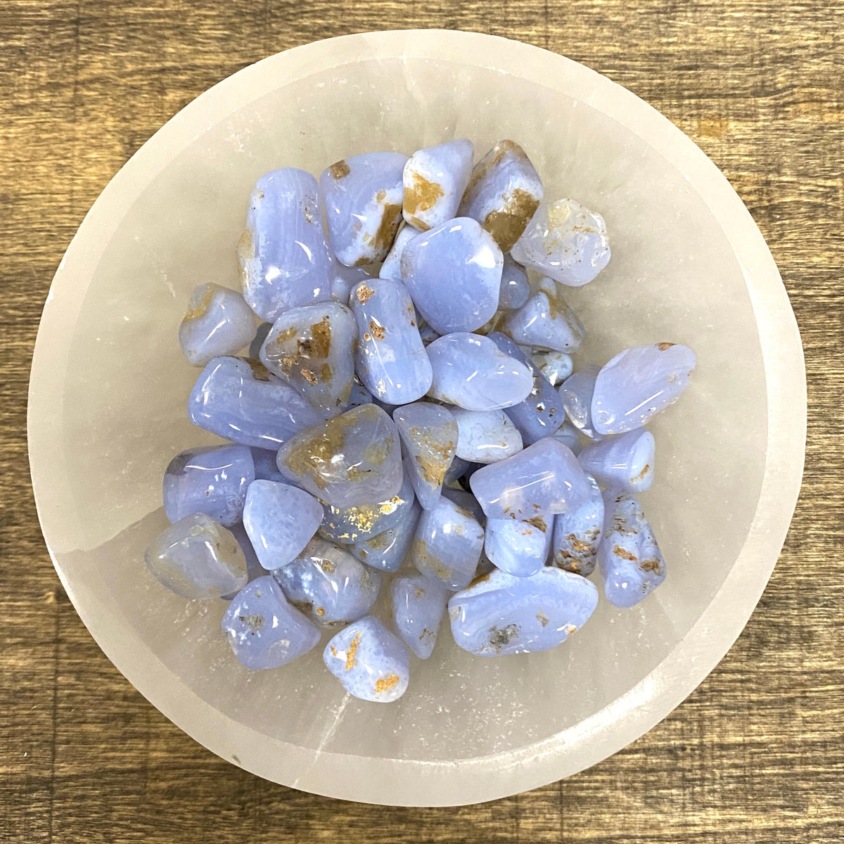 Overhead shot of various Blue Agate tumbled stones in a small bowl.