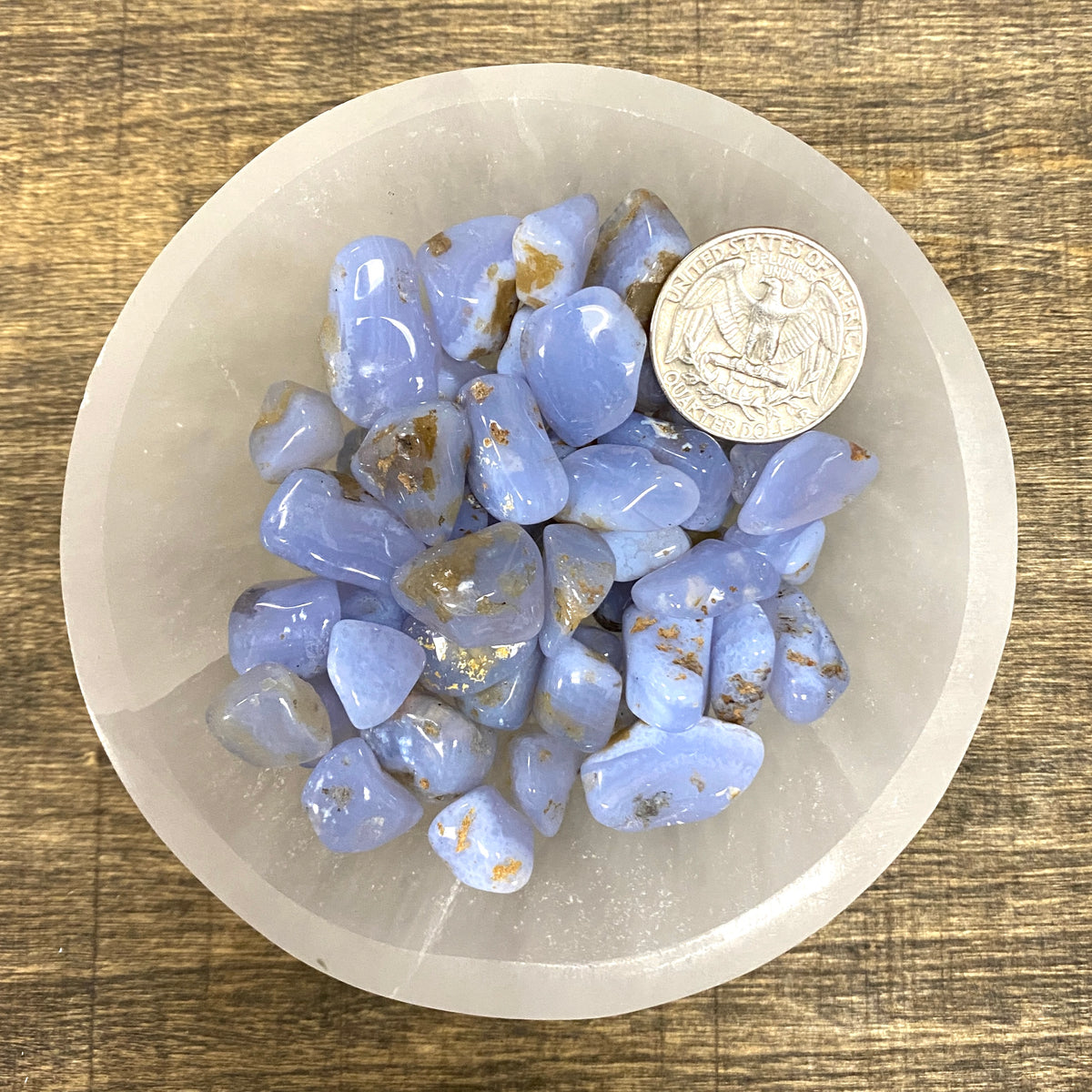 Overhead shot of various Blue Agate tumbled stones in a small bowl.