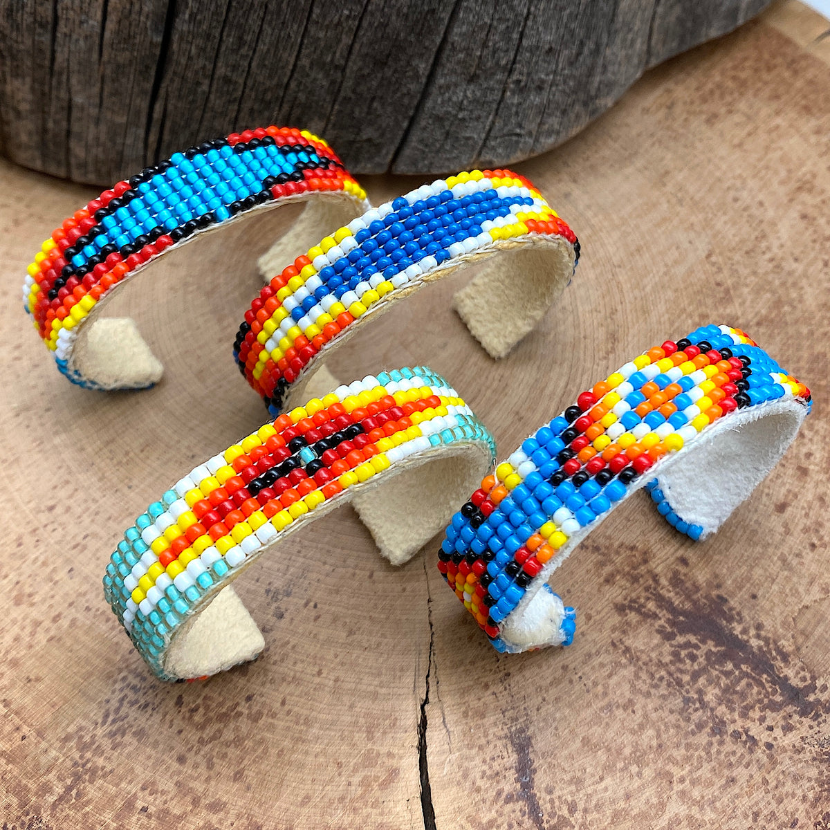 Beaded baby bracelets of various patterns and colors laid together