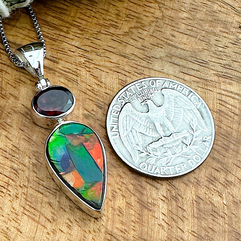 Comparison shot of a US quarter coin and an Ammolite pendant