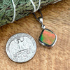 Comparison shot of a US quarter coin and an Ammolite pendantComparison shot of a US quarter coin and an Ammolite pendant