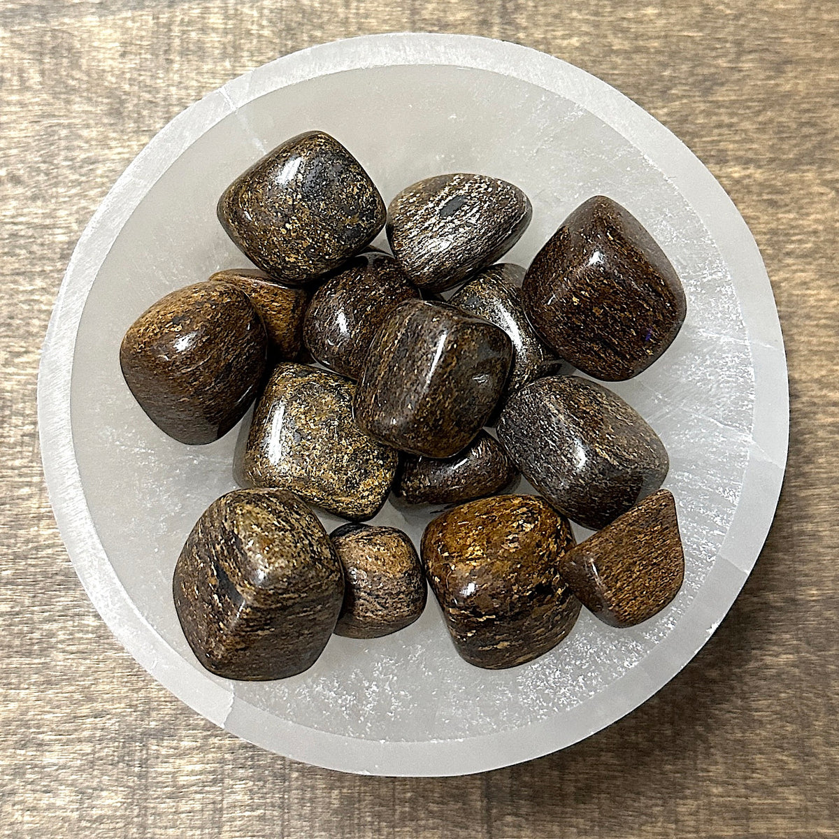 Shot of various bronzite tumbled stones in a small bowl