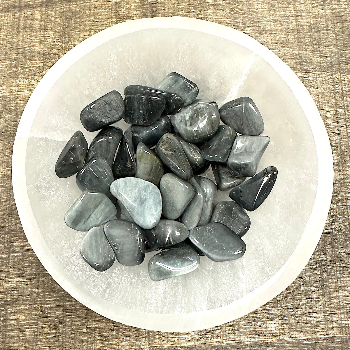 Shot of various Cat's Eye tumbled stones in a bowl