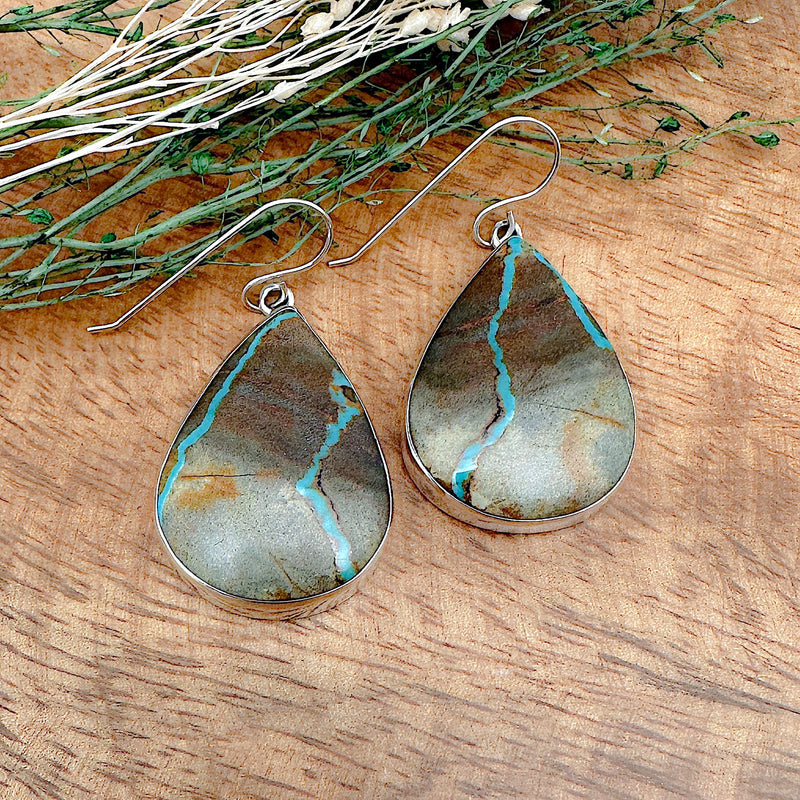Shot of a pair of boulder turquoise earrings