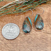 Comparison shot of a US quarter coin and a pair of boulder turquoise earrings