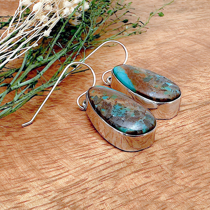 Shot of a pair of boulder turquoise earrings as viewed from the side