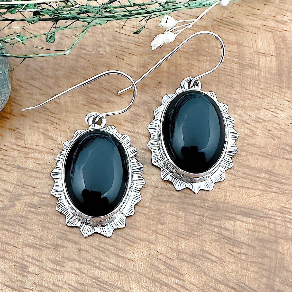 Front of a set of two Black Onyx earrings in an oval shape