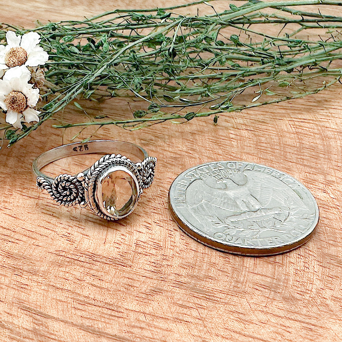Comparison shot of a US quarter coin and a citrine ring