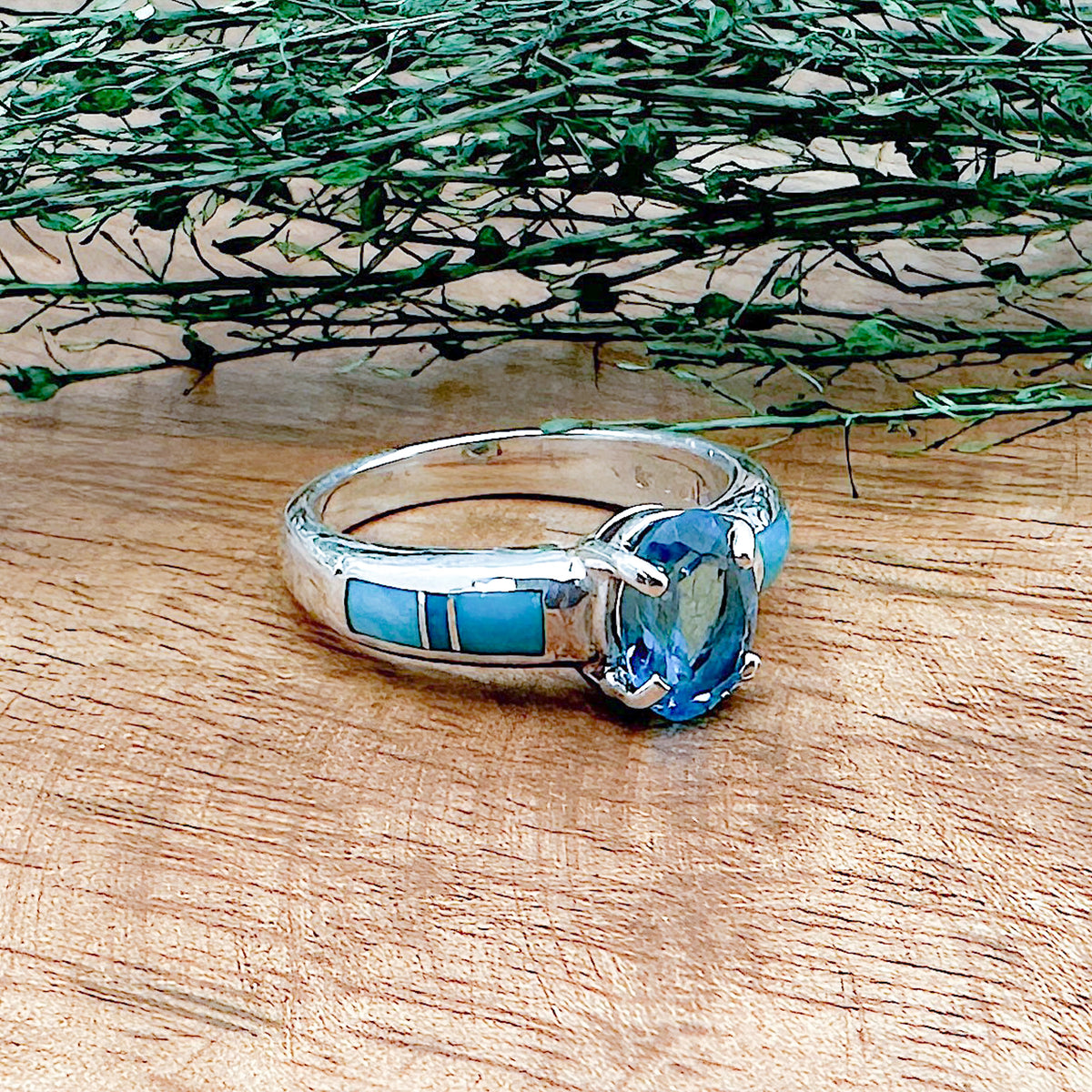 A handmade sterling silver ring that has 6 hand cut stones with Sleeping Beauty Turquoise and a London Blue Topaz on top that is a part of the David Rosales collection.