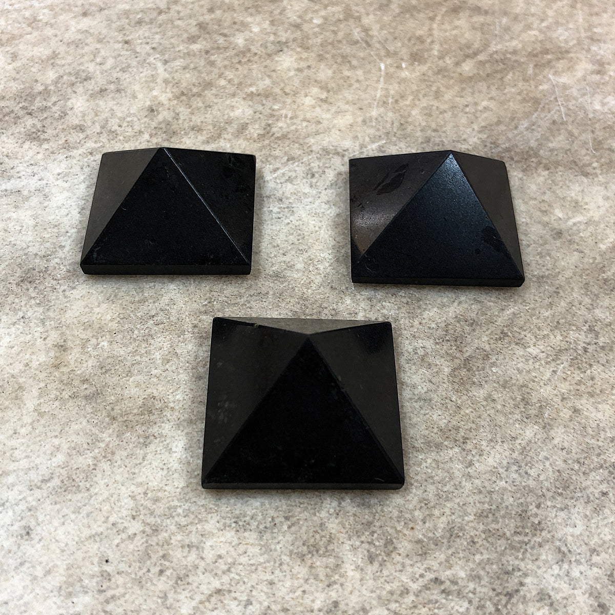 Shot of a group of three black tourmaline pyramids